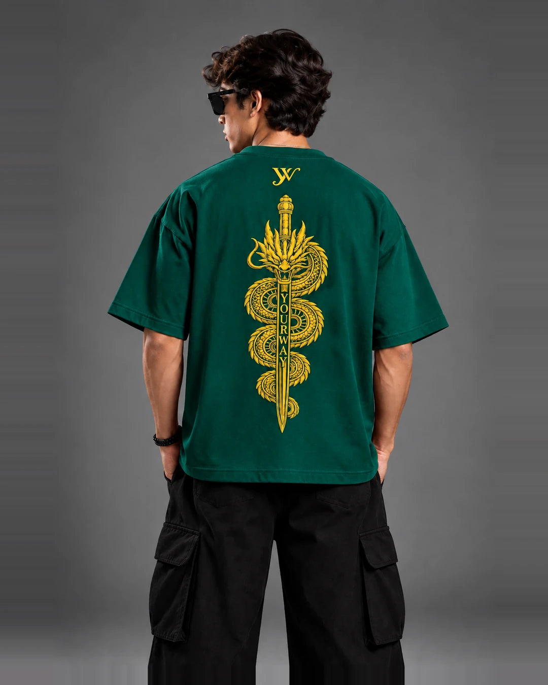 Studio portrait of model wearing the Teal Dragon Sword T-Shirt, back view with golden dragon and sword graphic