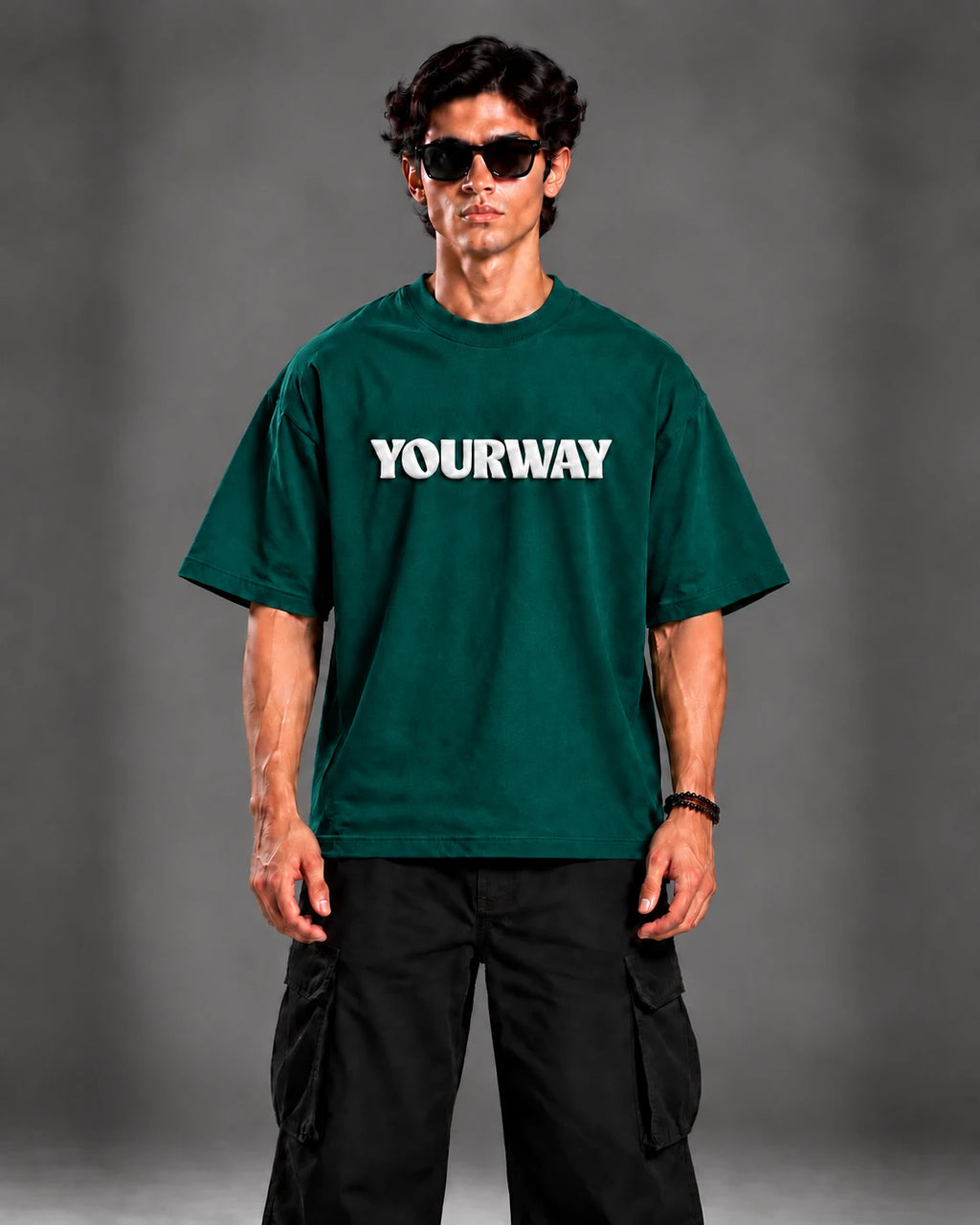 Model wearing the Emerald Green T-Shirt, front view styled with black cargo pants