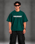 Model wearing the Emerald Green T-Shirt, front view styled with black cargo pants