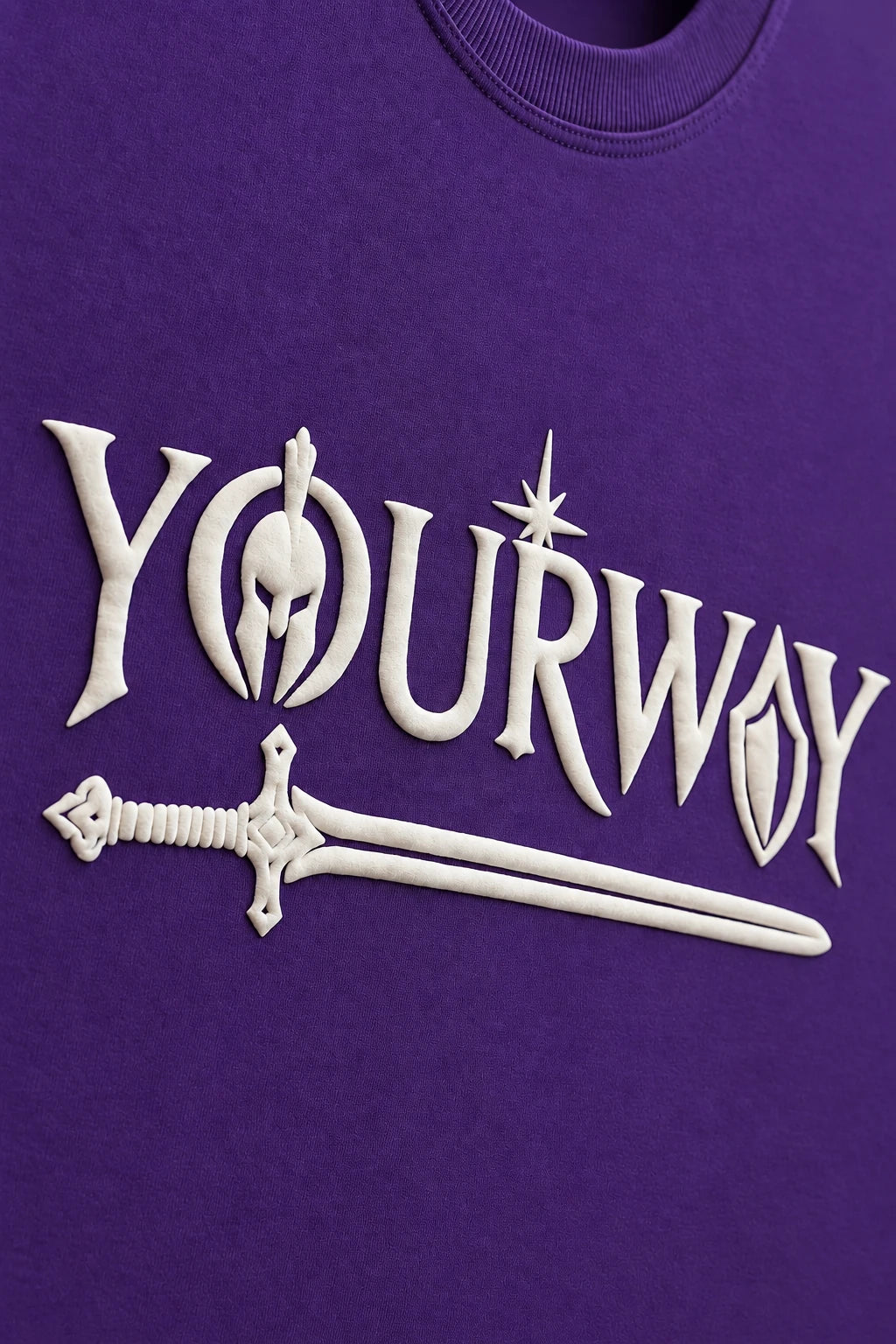 Purple Warrior T-Shirt front print close-up - YOURWAY sword and shield wordmark on purple fabric