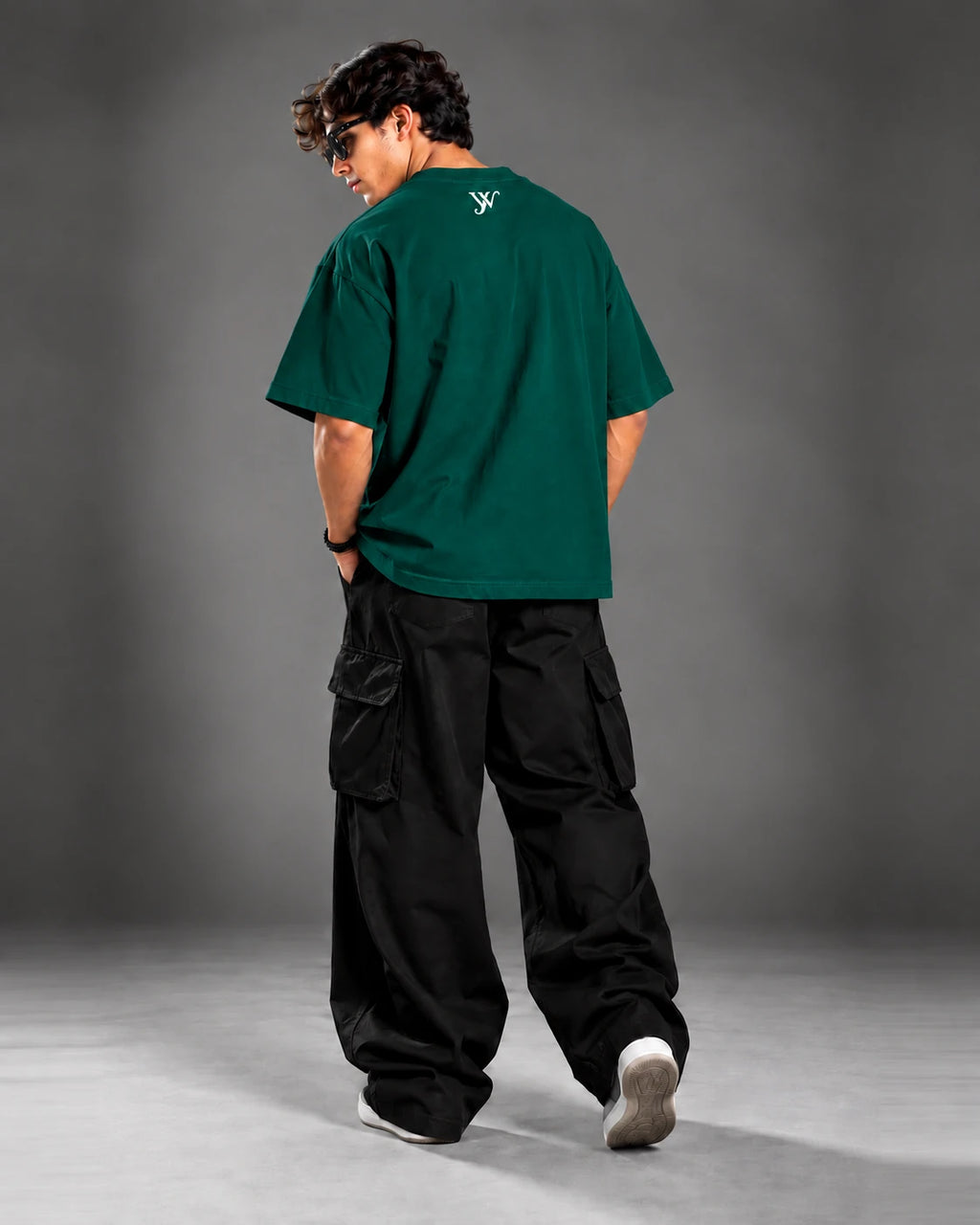 Model wearing the Emerald Green T-Shirt, back view showing the YW monogram print