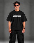 Model wearing the Black T-Shirt, back view walking pose with YW monogram print