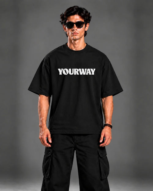 Model wearing the Black T-Shirt, back view walking pose with YW monogram print