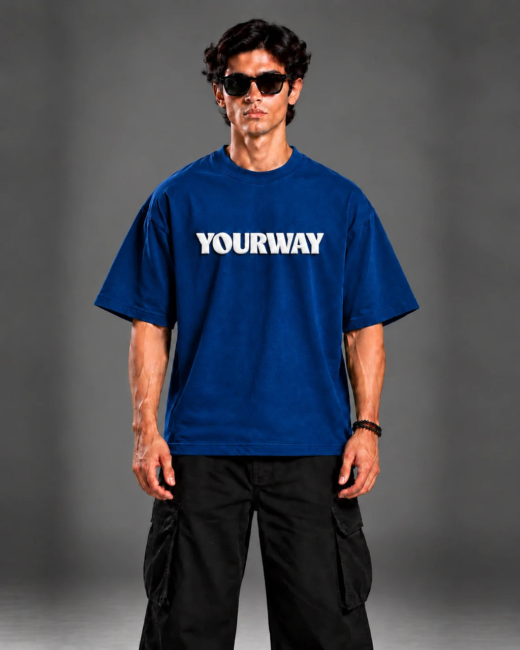 Model wearing the Navy Blue T-Shirt, front view styled with black cargo pants