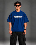 Model wearing the Navy Blue T-Shirt, front view styled with black cargo pants
