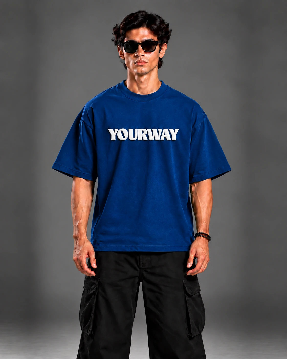 Model wearing the Navy Blue T-Shirt, front view styled with black cargo pants