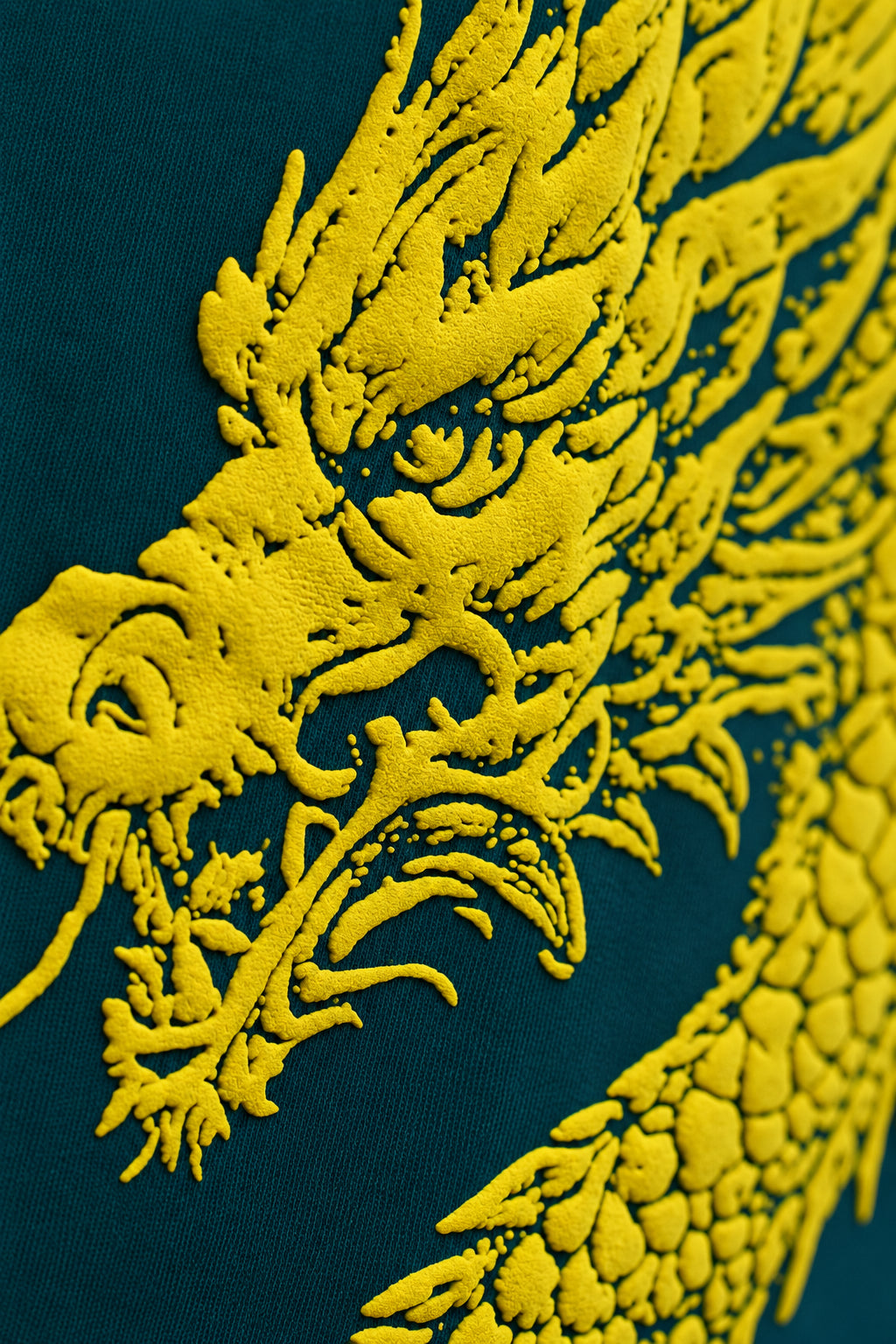 Close-up of the dragon head detail on the Teal Dragon Sword T-Shirt fabric