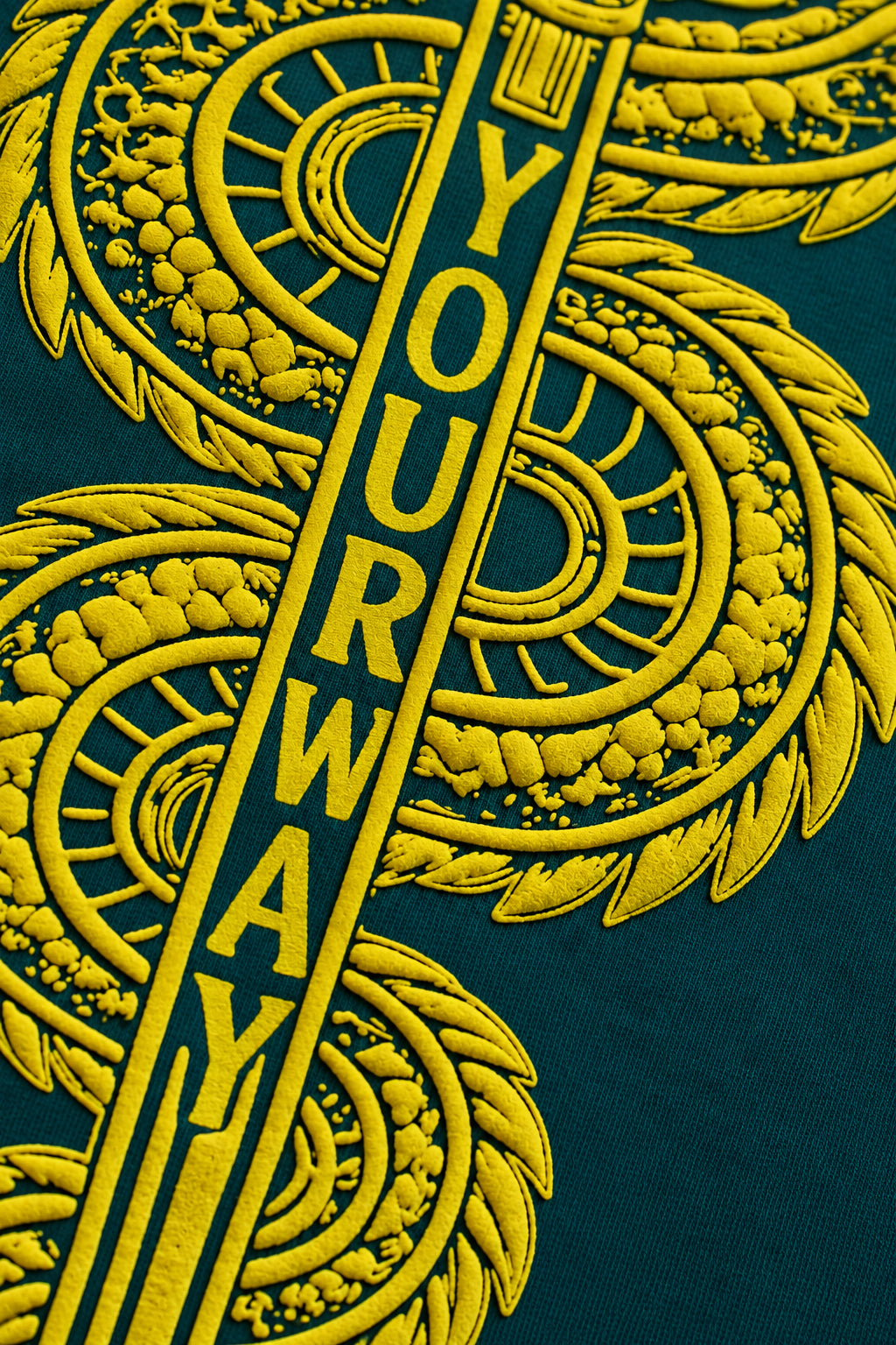 Close-up of the YOURWAY wordmark engraved on the sword blade on the Teal Dragon Sword T-Shirt