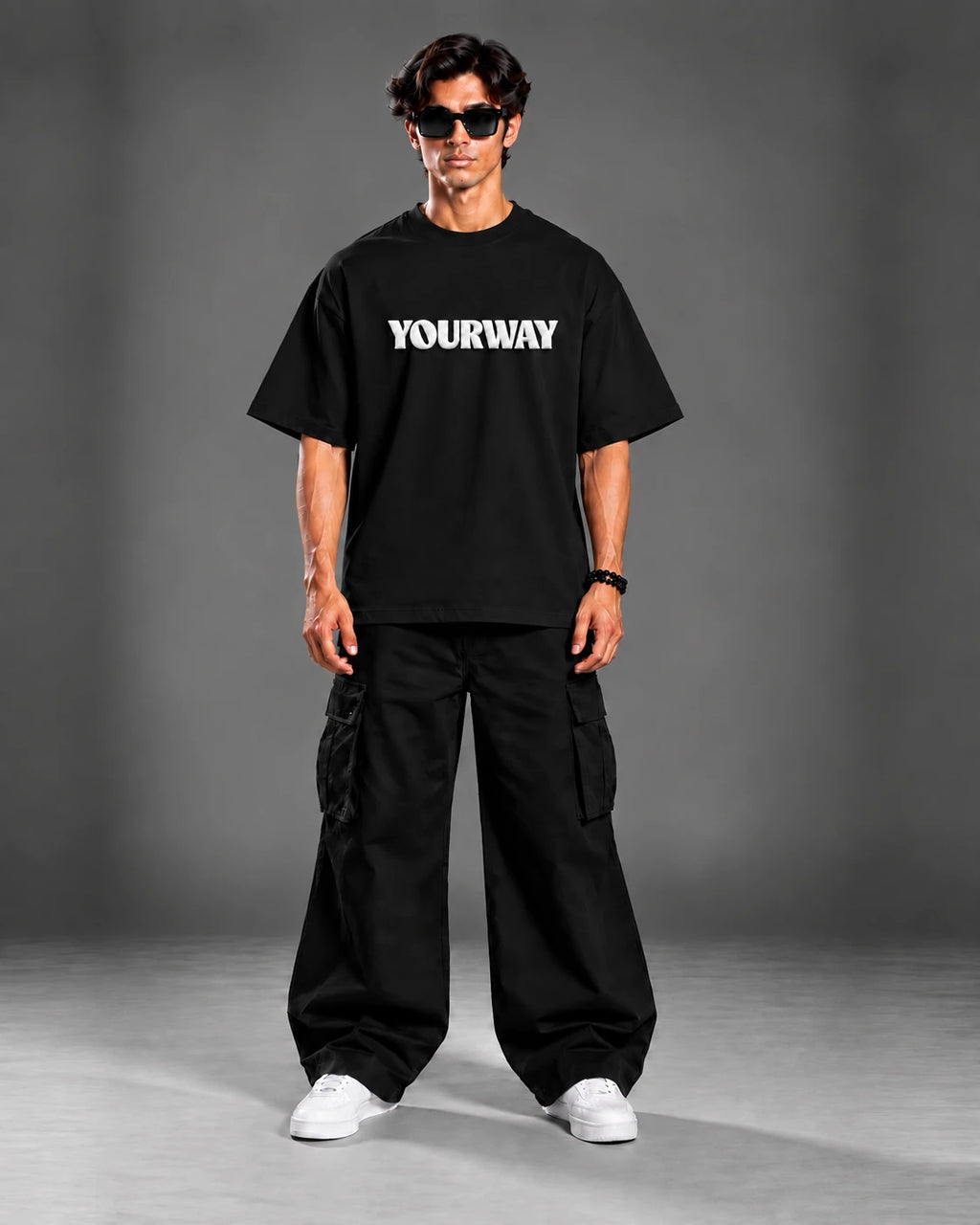 Studio portrait of model wearing the Black T-Shirt, back view with YW monogram print on the collar
